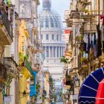 Scene in Old Havana with the Capitol building on the background